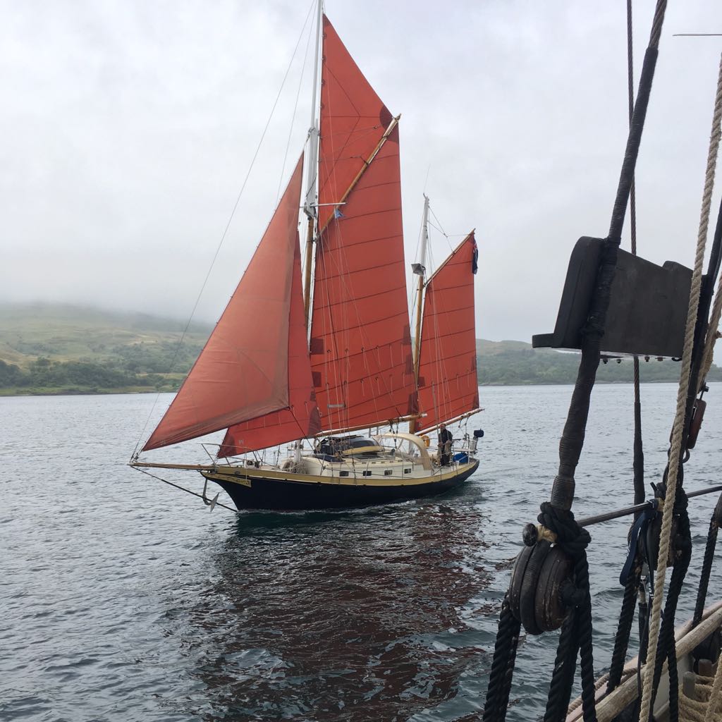 Meander under sail with her distinctive tan gaff-ketch sail plan